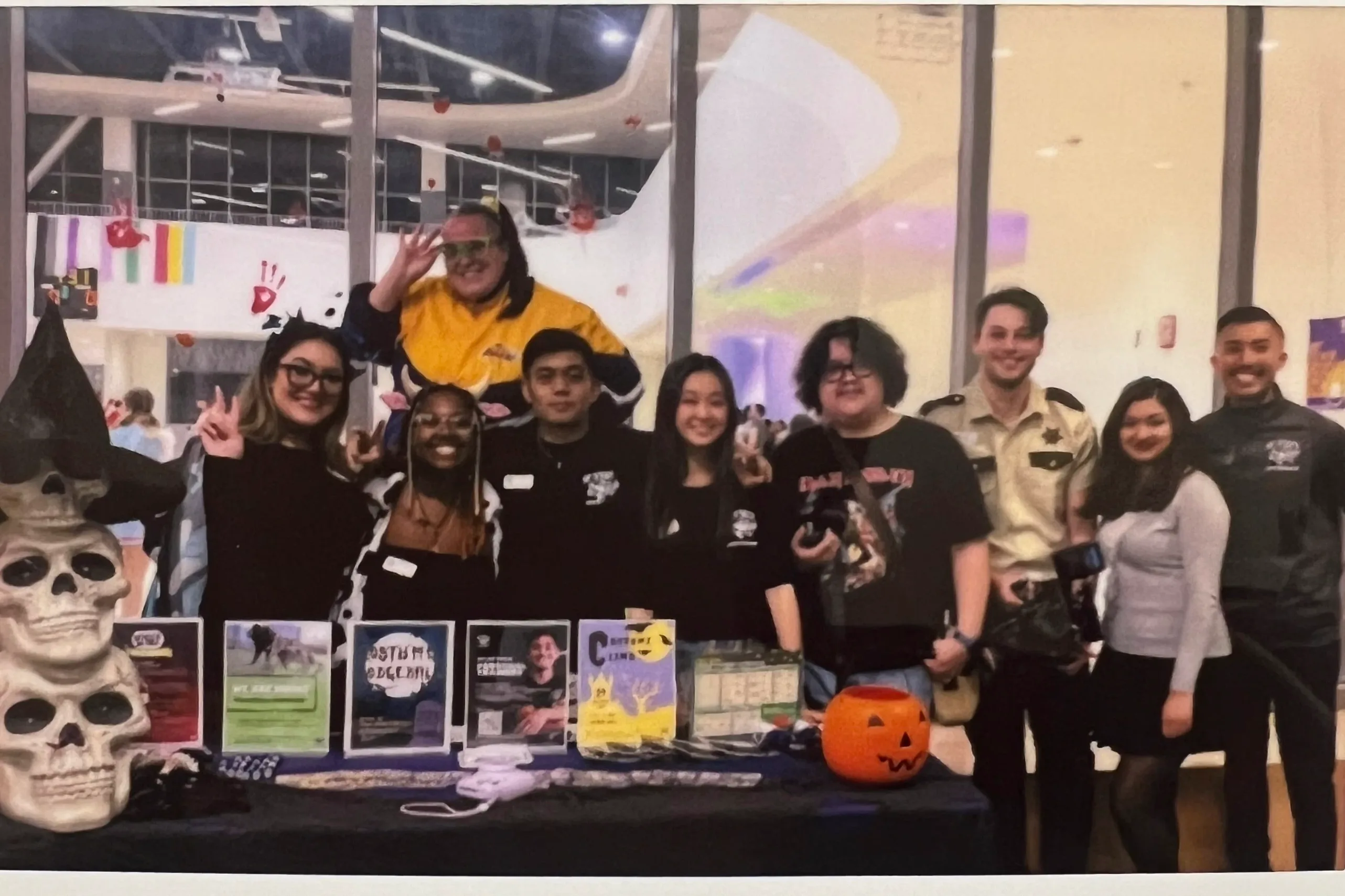 The Campus Recreation student staff behind a table at a Halloween event, with printed flyers standing on the table.